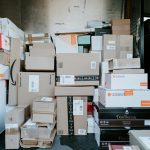 A stack of cardboard shipping boxes inside the back of a delivery van